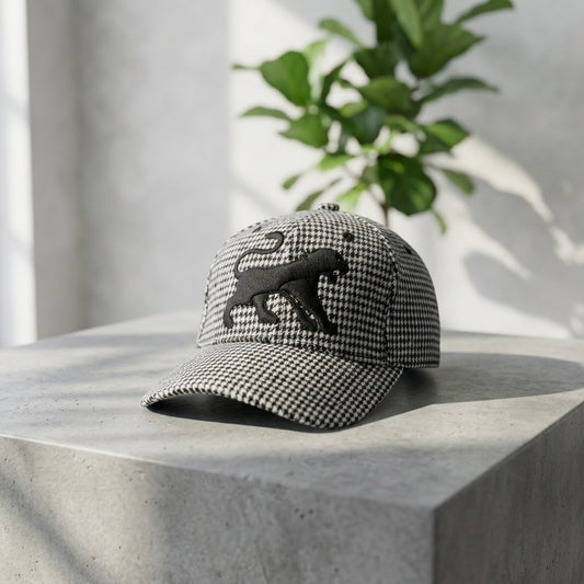 Houndstooth Classic Wool Cap on a minimalist concrete table with green leafy shadows