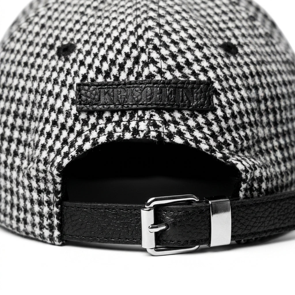 Close-up detail of the adjustable leather strap and embossed leather patch on the back of the Houndstooth Classic Wool Cap
